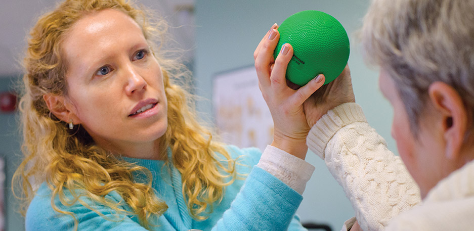 nurse and resident with ball