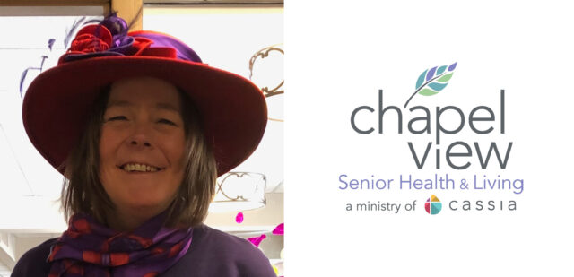 Brandy Lewis, Director of Housing at Chapel View Senior Living, smiling warmly while wearing a vibrant red hat and purple scarf. The Chapel View Senior Health & Living logo is displayed beside her, reflecting the caring and engaging environment she helps to foster.