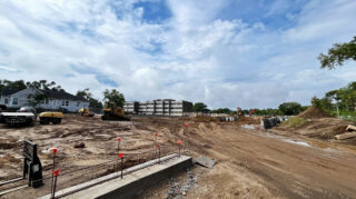 Wide view of Chapel View Care Center construction site in Hopkins with heavy equipment and early foundation work, September 2025.