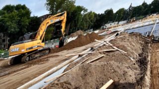 Excavator moving soil along the perimeter of Chapel View Care Center construction site, showing excavation progress, September 2025.