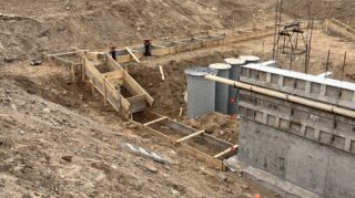 Ground-level view of initial framing and plumbing setup at Chapel View site.